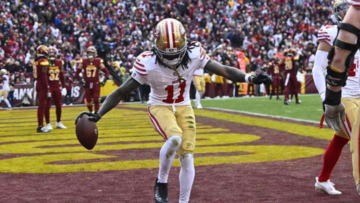 Dec 31, 2023; Landover, Maryland, USA; San Francisco 49ers wide receiver Brandon Aiyuk (11) celebrates a TD reception against the Commanders. 